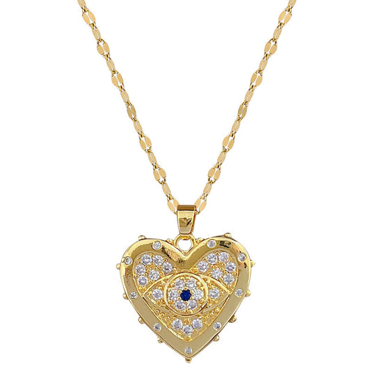 un collier en or avec un cœur maléfique et des yeux maléfiques